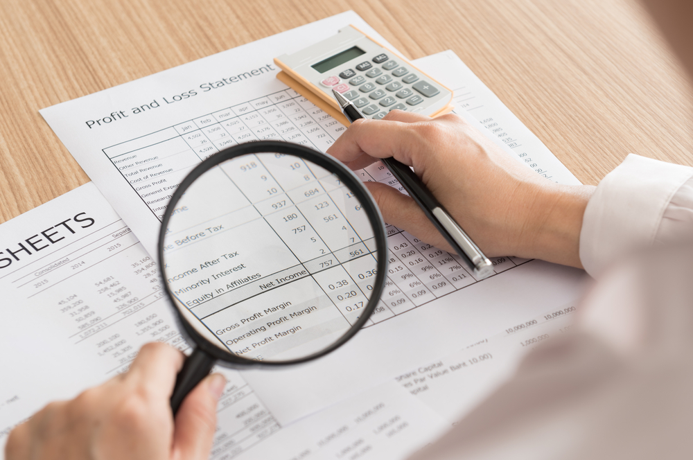 Auditor,Checking,Financial,Statement,With,Magnifying,Glass.,Audit,Concept.,Top